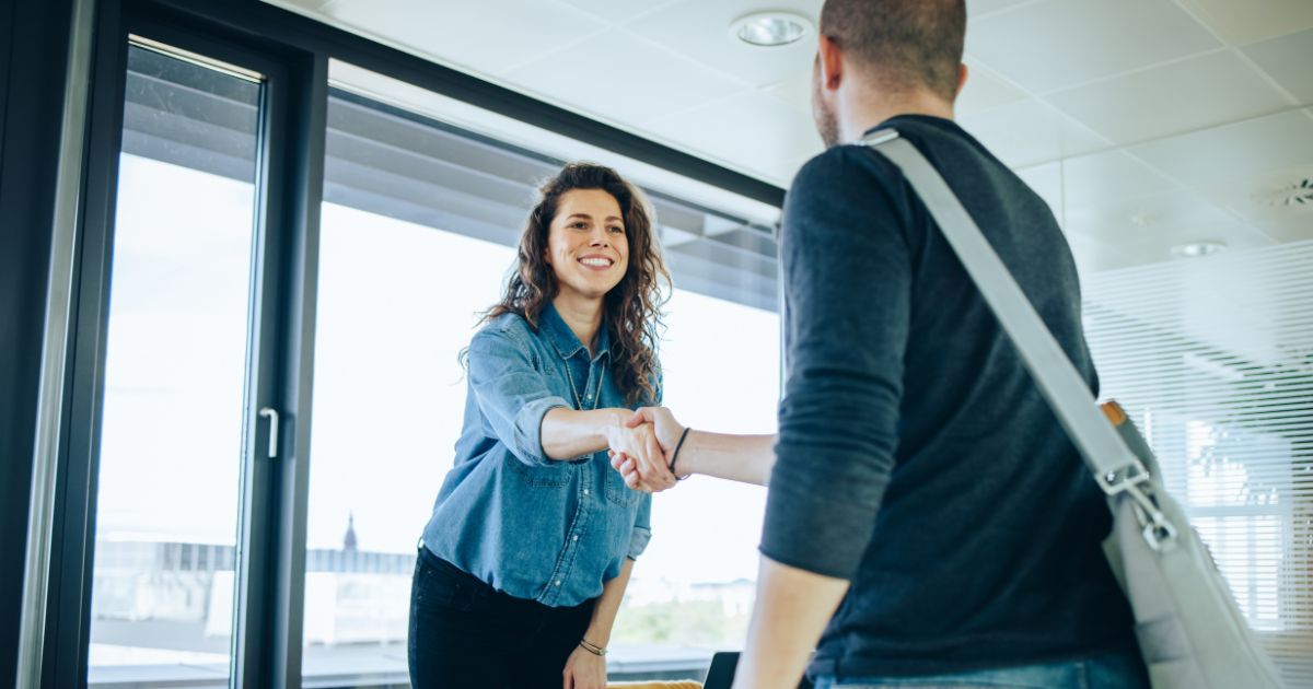 Recruiter greeting a candidate. Candidate experience is always the key, especially during economic downturn with less open positions.